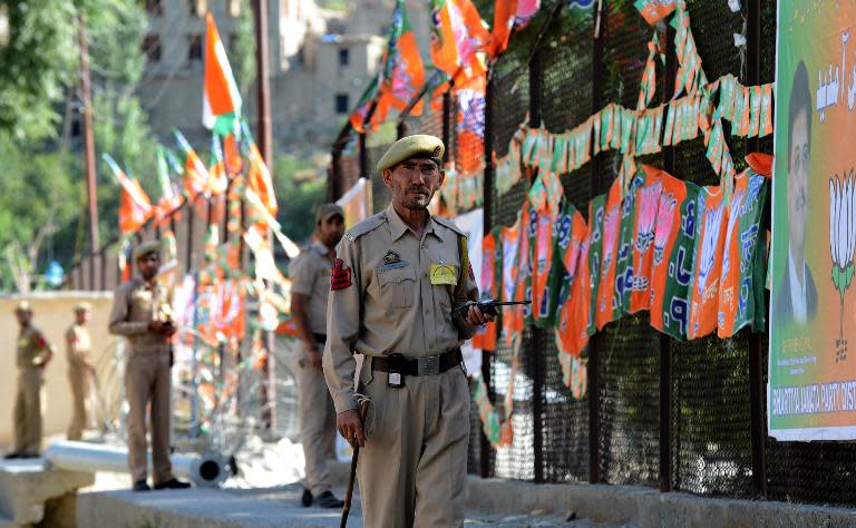 Indian policemen inspect the site of a public rally ahead of a visit by Prime Minister Narendra Modi in Kargil on August 12, 2014