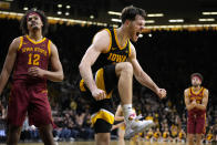 Iowa forward Filip Rebraca celebrates ahead of Iowa State forward Robert Jones (12) after making a basket during the second half of an NCAA college basketball game, Thursday, Dec. 8, 2022, in Iowa City, Iowa. (AP Photo/Charlie Neibergall)