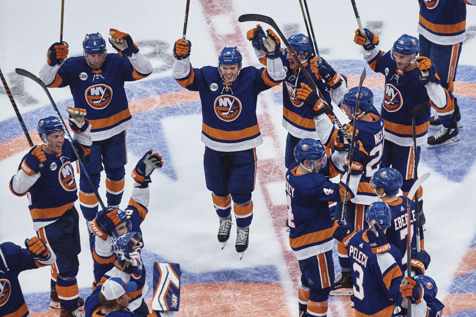 New York Islanders players celebrate their victory against the Columbus Blue Jackets in an NHL hockey game Saturday, Dec. 1, 2018, in Uniondale, N.Y. (AP Photo/Andres Kudacki)