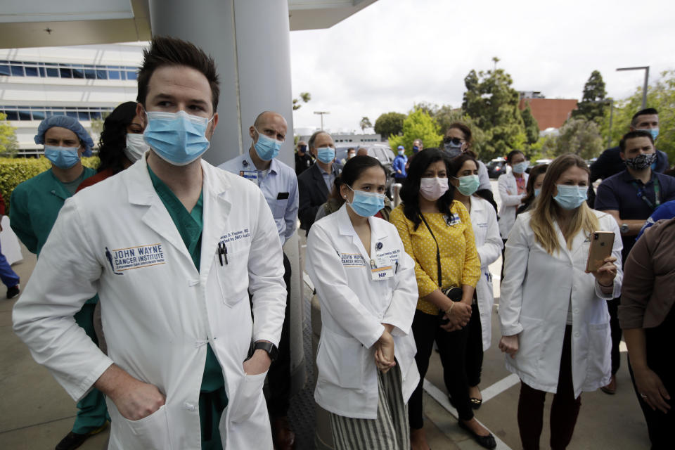 FILE - In this April 17, 2020, file photo, hospital personnel stand outside Providence St. John's Medical Center in Santa Monica, Calif. California hit more than 1,000 deaths linked to the coronavirus on Friday, April 17, 2020, according to a tally by Johns Hopkins University. (AP Photo/Marcio Jose Sanchez, File)