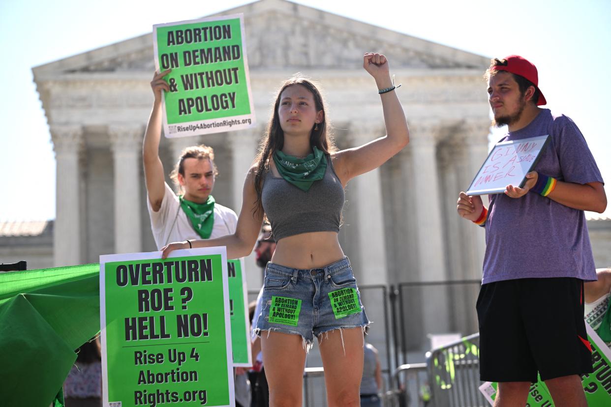 Pro-choice activists are seen outside of the US Supreme Court in Washington, DC, on June 15, 2022. - A draft opinion leaked in May would have the conservative majority on the nine-member court overturn Roe v. Wade, the 1973 landmark decision allowing nationwide access to abortion. (Photo by MANDEL NGAN / AFP) (Photo by MANDEL NGAN/AFP via Getty Images)