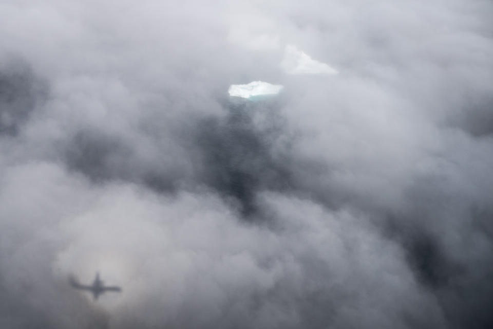 In this photo taken on Wednesday, Aug. 14, 2019, Icebergs are covered by clouds near Kulusuk, Greenland. Greenland has been melting faster in the last decade and this summer, it has seen two of the biggest melts on record since 2012. (AP Photo/Felipe Dana)