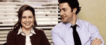 Pam and Jim smiling at one another in "The Office."