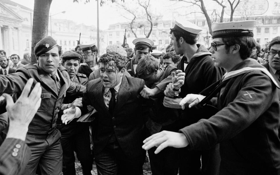 A man believed to be a government agent is escorted away by soldiers during the unrest following the Carnation Revolution - Henri Bureau/Sygma/Corbis/VCG via Getty Images