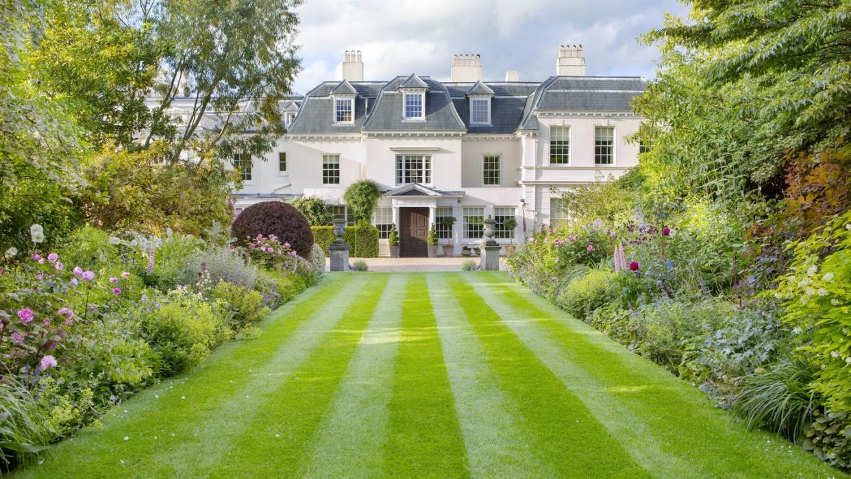 italianate estate in goudhurst, england design by jo thompson landscape garden design a double herbaceous border with purple berberis, ornamental grasses, agastache, roses, nepeta, and other perennials defines the entry