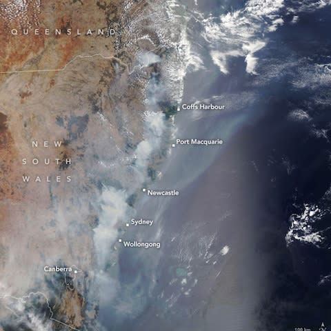 A handout photo made available by NASA Earth Observatory of a satellite image showing fires burning across New South Wales in December