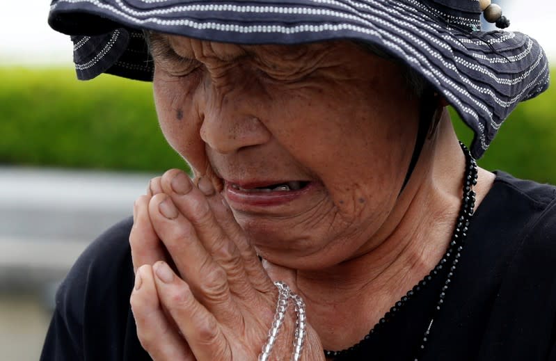 FILE PHOTO: Ikegami, 84, prays in front of the cenotaph for the victims of the 1945 atomic bombing, at Peace Memorial Park in Hiroshima