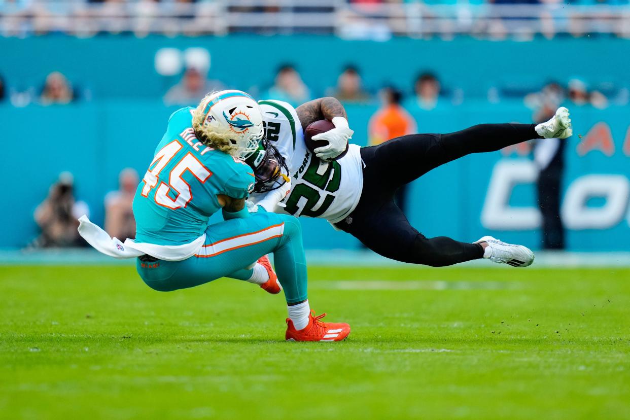 Jan 8, 2023; Miami Gardens, Florida, USA; Miami Dolphins linebacker Duke Riley (45) tackles New York Jets running back Ty Johnson (25) during the first quarter at Hard Rock Stadium. Mandatory Credit: Rich Storry-USA TODAY Sports