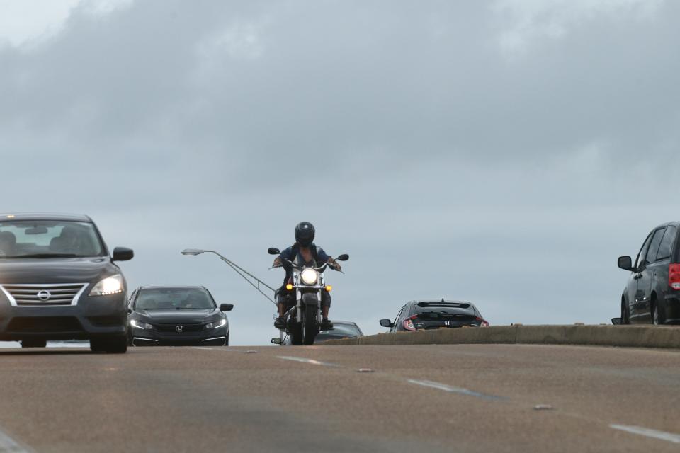 A motorcyclist is surrounded by cars as he cross the Brooks Bridge onto Okaloosa Island Friday. There were 28 motorcycle crashes reported in Okaloosa County last year, with almost half of them fatal, according to the Florida Department of Highway Safety and Motor Vehicles.