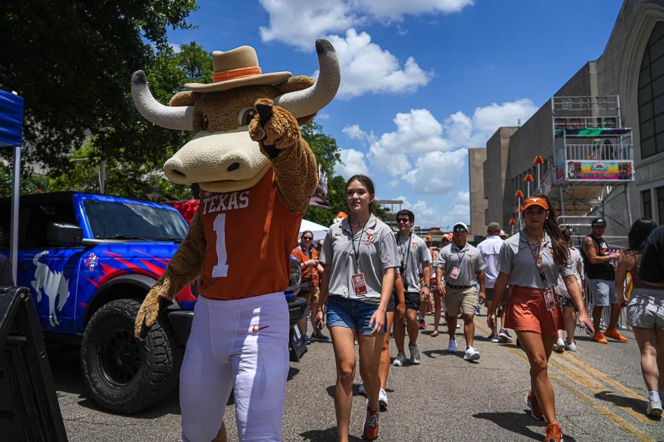 Texas mascot Hook 'Em walks through the crowd during Sunday's SEC celebration on the UT campus. The Longhorns officially join the SEC on Monday, creating a 16-team power conference that should be the most competitive league in several collegiate men's and women's sports.