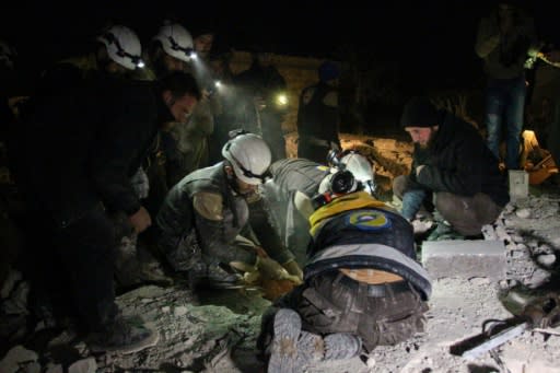 Syrian rescue workers search for survivors following air strikes on the village of Abin Semaan in Aleppo province