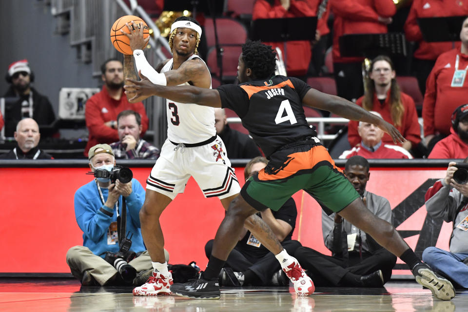 Louisville guard El Ellis (3) looks for help from the pressure from Miami guard Bensley Joseph (4) during the first half of an NCAA college basketball game in Louisville, Ky., Sunday, Dec. 4, 2022. (AP Photo/Timothy D. Easley)