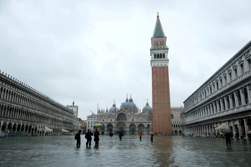 FILE PHOTO: People wade through the flooded St. Mark's Square during a period of seasonal high water in Venice