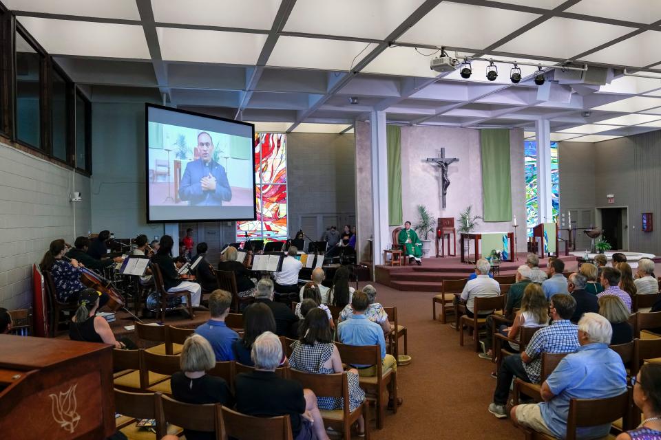 Jul 3, 2022; Columbus, Ohio, USA;  Rev. Rene Costanza delivers a video taped message at the Newman Center, the parish and student ministry at Ohio State, letting parishioners know that the diocese is being taken from the Paulist fathers during Catholic mass on July 3, 2022. Mandatory Credit: Adam Cairns-The Columbus Dispatch