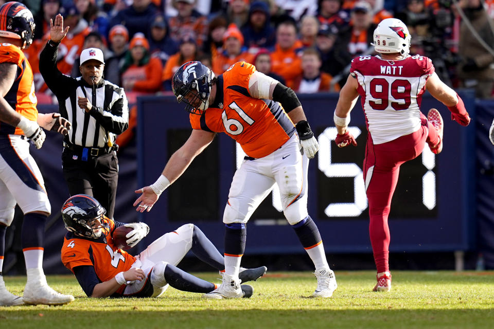 Arizona Cardinals defensive end J.J. Watt (99) celebrates his sack as Denver Broncos guard Graham Glasgow (61) helps quarterback Brett Rypien (4) up during the first half of an NFL football game, Sunday, Dec. 18, 2022, in Denver. (AP Photo/Jack Dempsey)