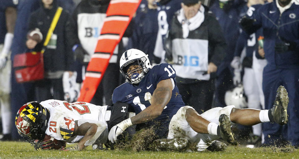 FILE - In this Nov. 24, 2018, file photo, Penn State's Micah Parsons (11) drags down Maryland's Javon Leake (20) for a loss during the second half of an NCAA college football game in State College, Pa. Last year, Micah Parsons put together the greatest freshman season for a linebacker in Penn State history while only starting one game. He learned that making a bunch of tackles wasn't enough to be a starter. (AP Photo/Chris Knight, File)
