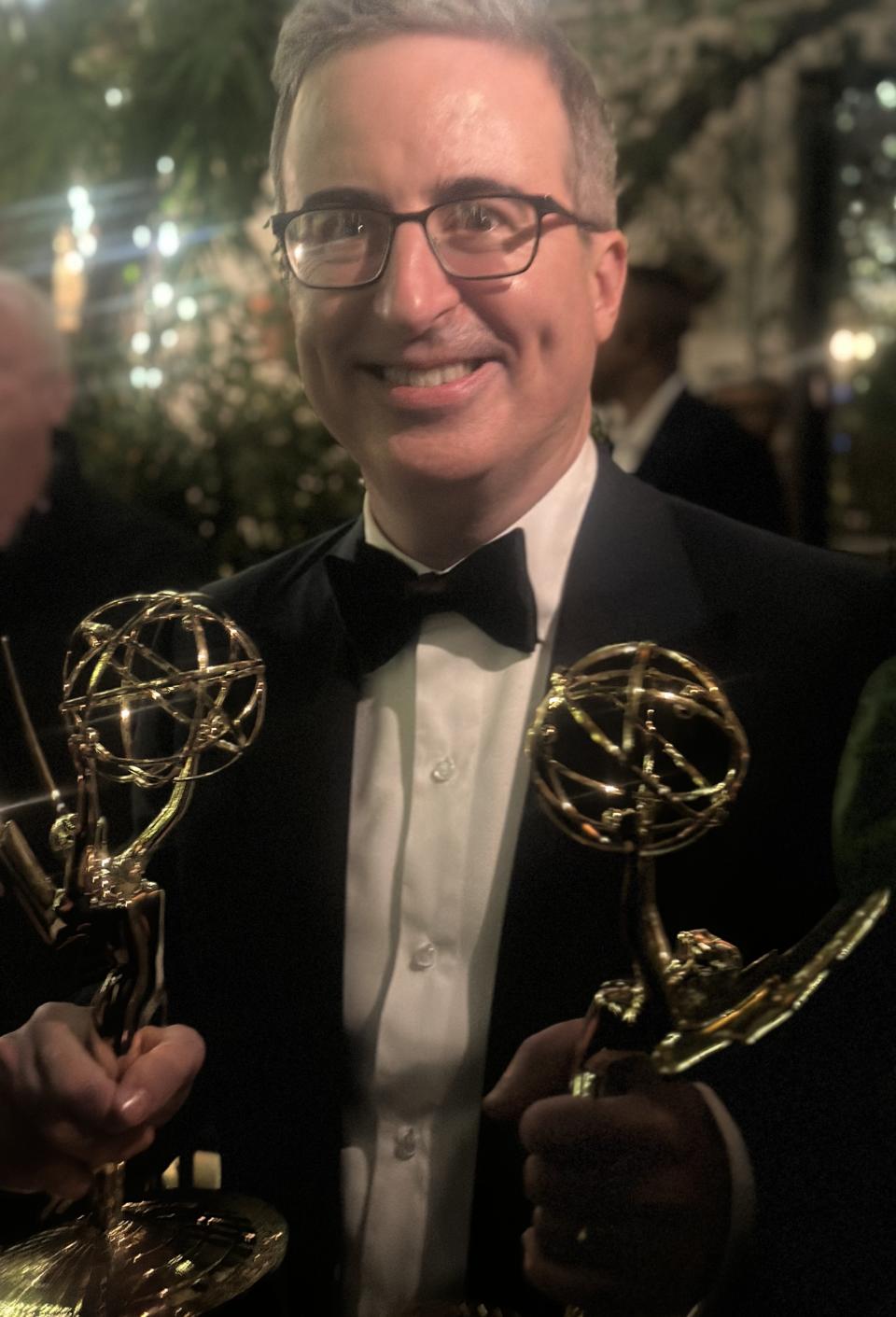 John Oliver with his dual Emmys (Baz Bamigboye/Deadline)