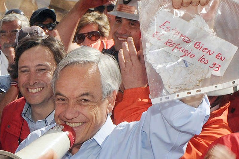 Chile's President Sebastian Pinera holds a note from miners trapped in a collapsed mine in Copiapo, Chile, on August 22, 2010. The note says the miners, 33 of them, are OK in a refuge. On August 23, 2010, rescuers made their first radio contact with the trapped miners. UPI File Photo