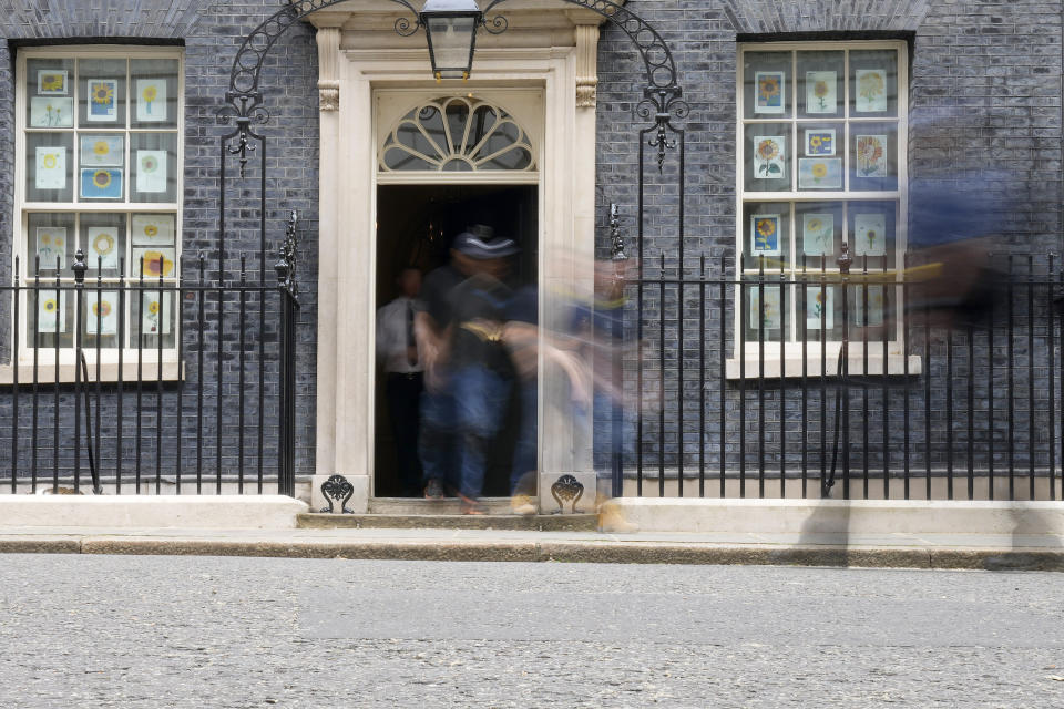 People leave and arrive at 10 Downing Street in London, Monday, May 23, 2022. The general public is awaiting the release of Sue Gray's report into COVID lockdown breaches across Whitehall, the so called "Partygate". (AP Photo/Frank Augstein)
