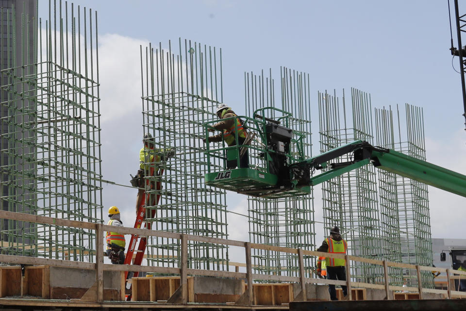 FILE - In this April 16, 2020, file photo work continues on a bridge on the Interstate Highway 75 project in Troy, Mich. Looking beyond the $1.9 trillion COVID relief bill, President Joe Biden and lawmakers are laying the groundwork for another of his top legislative priorities — a long-sought boost to the nation's roads, bridges and other infrastructure that could meet GOP resistance to a hefty price tag. (AP Photo/Carlos Osorio, File)