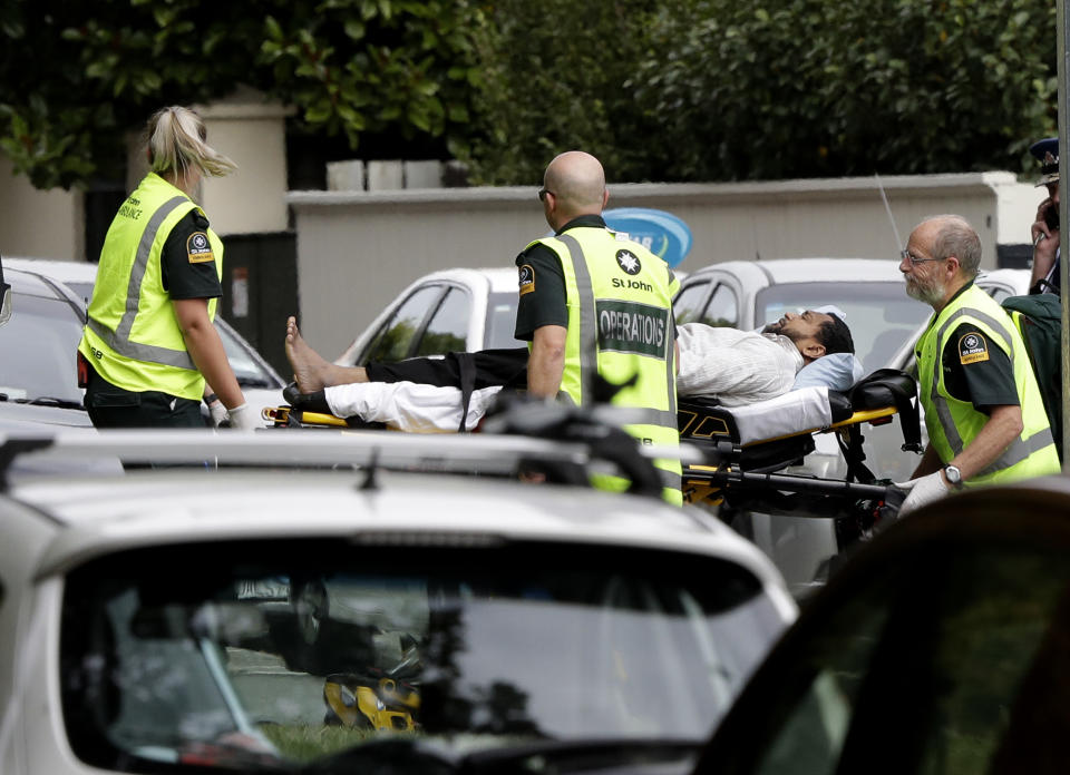 Ambulance staff take a man from outside a mosque in central Christchurch, New Zealand, Friday, March 15, 2019. A witness says many people have been killed in a mass shooting at a mosque in the New Zealand city of Christchurch.(AP Photo/Mark Baker)