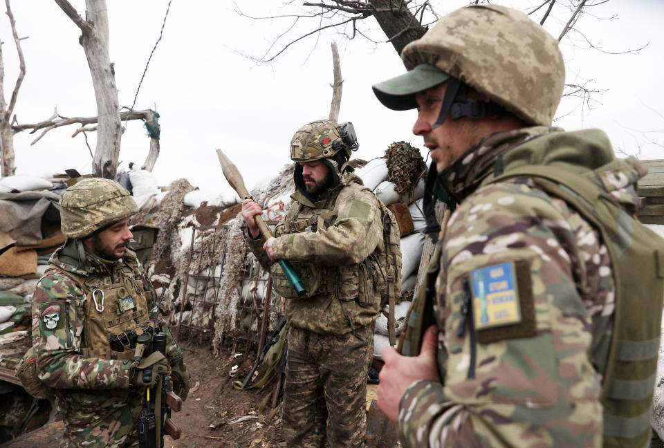 Ukrainian servicemen examine an RPG rocket in a trench in Donetsk, Ukraine  (Anatolii Stepanov / AFP via Getty Images file)