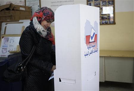 A woman marks her ballot in a voting booth during the municipal election at a polling station in Benghazi April 19, 2014. REUTERS/Esam Omran Al-Fetori