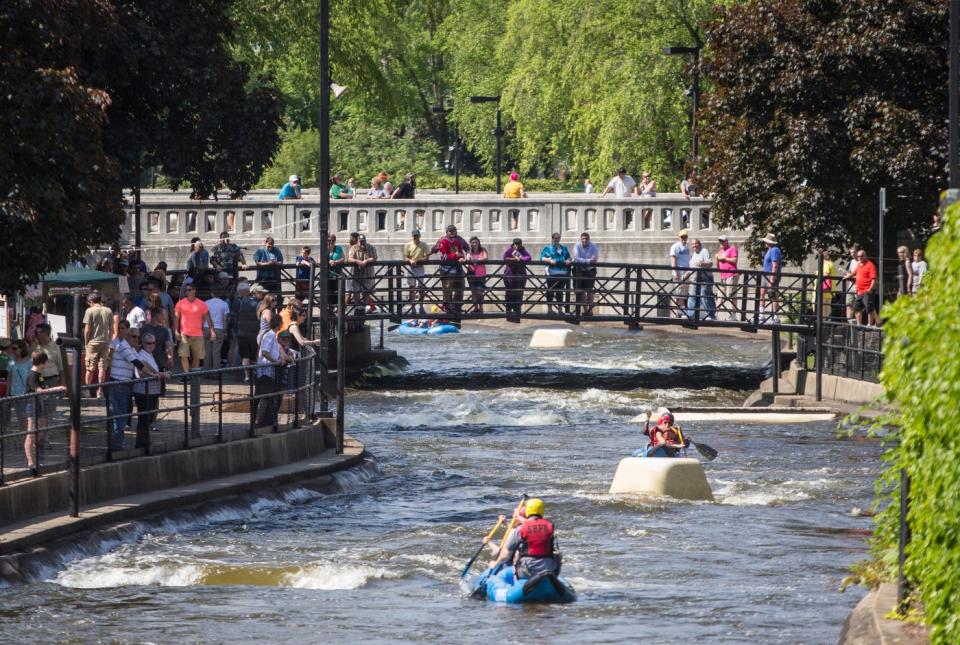 People look on as rafters take on the rapids on the East Race during the SB 150 celebration festivities on Saturday, May 23, 2015, in South Bend. The East Race opens for the season June 5, 2022. ROBERT FRANKLIN, SOUTH BEND TRIBUNE FILE