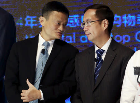 FILE PHOTO: Alibaba Founder and Chairman Jack Ma (L) talks to CEO Daniel Zhang at NYSE Bell Ringing ceremony during Alibaba Group's 11.11 Global shopping festival in Beijing, China, November 11, 2015. REUTERS/Kim Kyung-Hoon/File Photo