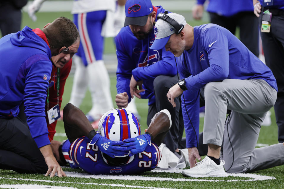 An injured Buffalo Bills cornerback Tre'Davious White (27) is helped by head coach Sean McDermott, right, and medical staff in the first half of an NFL football game against the New Orleans Saints in New Orleans, Thursday, Nov. 25, 2021. (AP Photo/Butch Dill)