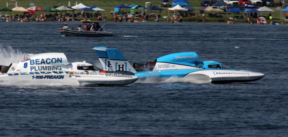 Corey Peabody in the U-9 Miss Beacon Electric unlimited hydroplane races past Dylan Runne in the U-1 Miss Homsetreet Bank during heat 1A of the Columbia Cup to claim victory in the 3-lap race. Runne was penalized one lap by race officials for a lane infraction during the race.