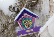 A bird house painted for Kindergarten teacher Victoria Soto is part of a memorial for the victims of the Sandy Hook Elementary School shooting in Newtown, Connecticut December 14, 2013 . Today marks the one year anniversary of the shooting rampage at Sandy Hook Elementary School, where 20 children and six adults were killed by gunman Adam Lanza. (REUTERS/Michelle McLoughlin)