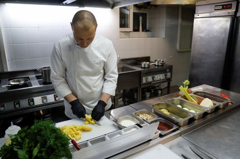 Ukrainian chef Marshal cooks borshch at a traditional cuisine restaurant in Kyiv