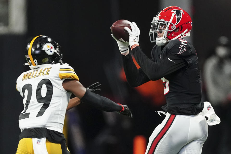 Atlanta Falcons wide receiver Drake London (5) makes the catch against Pittsburgh Steelers cornerback Levi Wallace (29) during the first half of an NFL football game, Sunday, Dec. 4, 2022, in Atlanta. (AP Photo/John Bazemore)