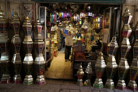 Issam Zughaiar, 67, a Palestinian vendor arranges lamp shades at his shop in a market in Jerusalem's Old City, May 10, 2017. REUTERS/Ammar Awad