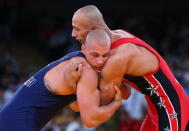 LONDON, ENGLAND - AUGUST 06: Damian Janikowski of Poland (L) competes with Karam Mohamed Gaber Ebrahim of Egypt during their Men's Greco-Roman 84 kg Wrestling Semi Final on Day 10 of the London 2012 Olympic Games at ExCeL on August 6, 2012 in London, England. (Photo by Cameron Spencer/Getty Images)