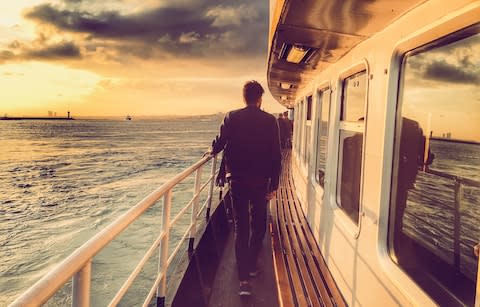 Man on deck cruise ship - Credit: Getty