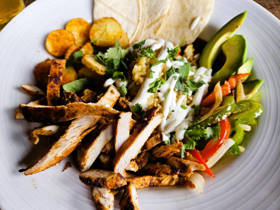 The Fiesta Bowl containing paprika spiced fingerling potatoes, Cajun rice, sauteed onions and peppers, fresh avocado, lima crema, corn tortillas and topped with blackened chicken photographed at Mattison's Riverwalk Grille in Bradenton on Aug. 20, 2023.