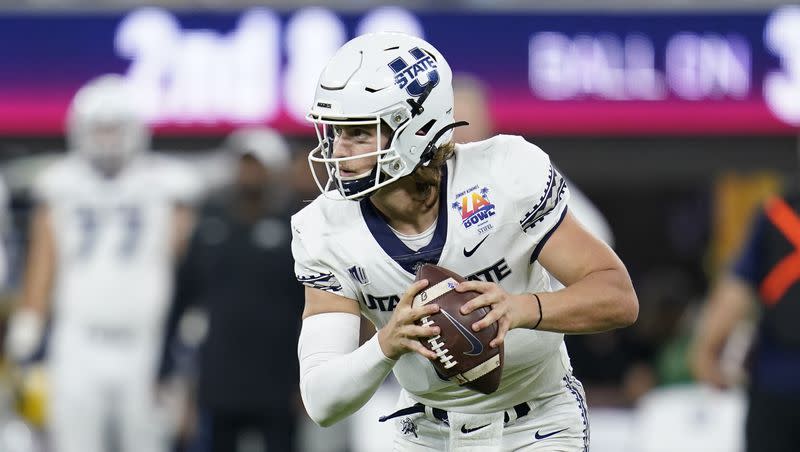 Utah State quarterback Cooper Legas (5) throws a pass during the LA Bowl NCAA college football game against Oregon State in Inglewood, Calif., Saturday, Dec. 18, 2021. Filling in for an injured McCae Hillstead Saturday at UConn, Legas was nearly flawless leading the Aggies to a comeback victory.