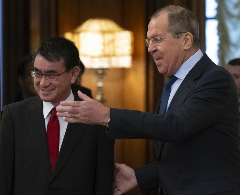 Russian Foreign Minister Sergey Lavrov, right, welcomes Japanese Foreign Minister Taro Kono for the talks in Moscow, Russia, Monday, Jan. 14, 2019. (AP Photo/Alexander Zemlianichenko)
