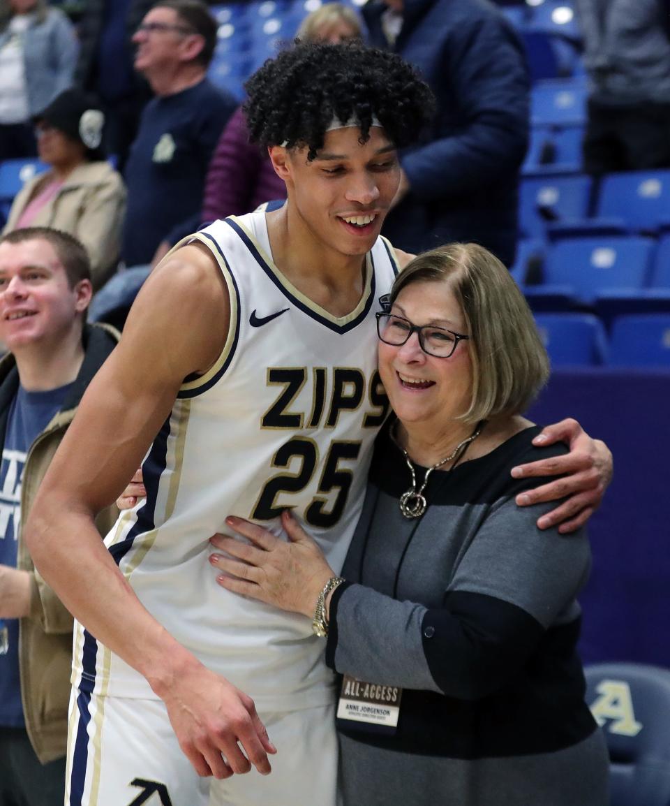 Akron forward Enrique Freeman hugs Anne Jorgensen after beating Ohio on Tuesday in Akron.