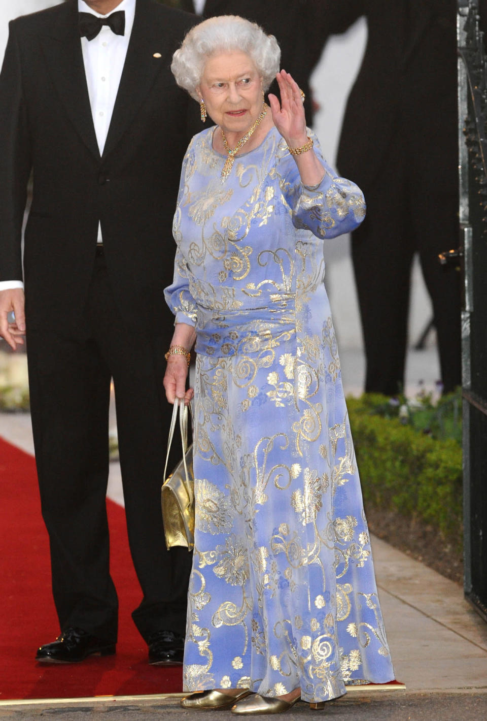 <p>The Queen wore this gorgeous lilac and gold number to the William and Kate’s pre-wedding dinner in April 2011. We want a pair of those gold shoes… <i>[Photo: Rex]</i></p>