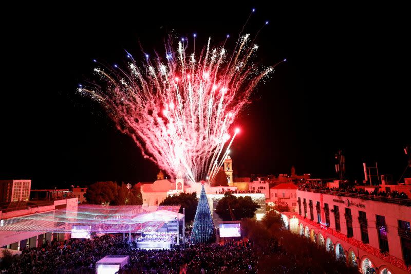 Palestinians light a Christmas tree in Bethlehem