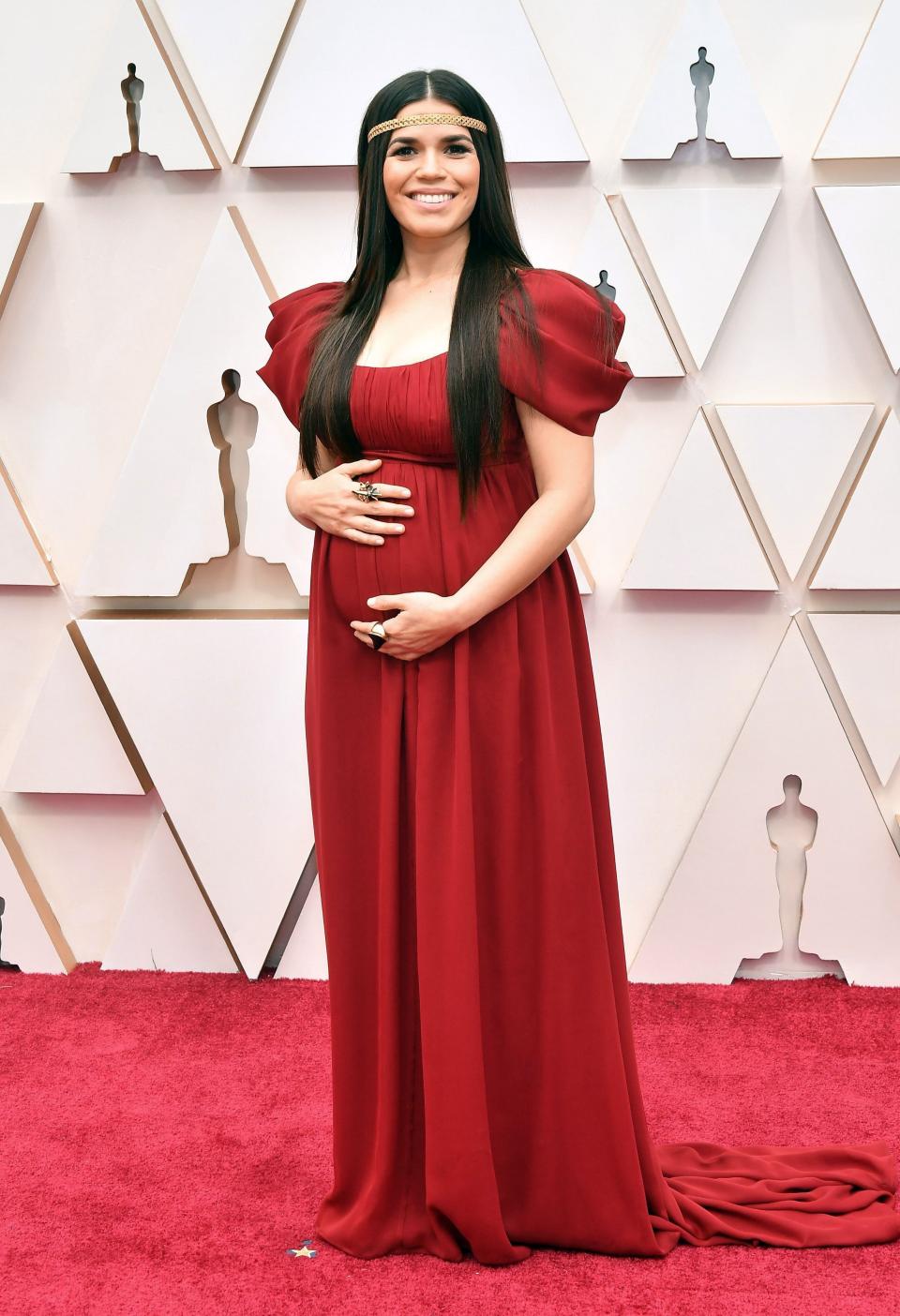 The expectant actress showed off her growing bump in a ruby red gown by Alberta Ferretti.