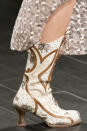 <p><i>White and brown printed leather cowboy boots from the SS18 Anna Sui collection. (Photo: ImaxTree) </i></p>