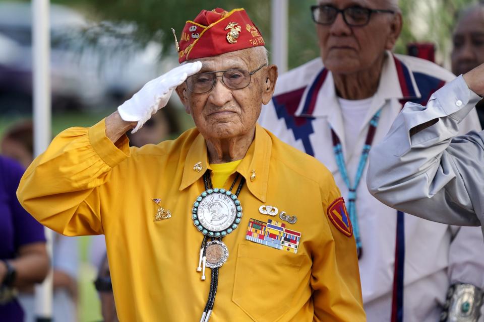 Navajo Code Talker Thomas Begay salutes during the national anthem at the Arizona State Navajo Code Talkers Day celebration, Sunday, Aug. 14, 2022, in Phoenix. (AP Photo/Ross D. Franklin)