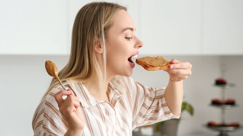 Person eating organic peanut butter