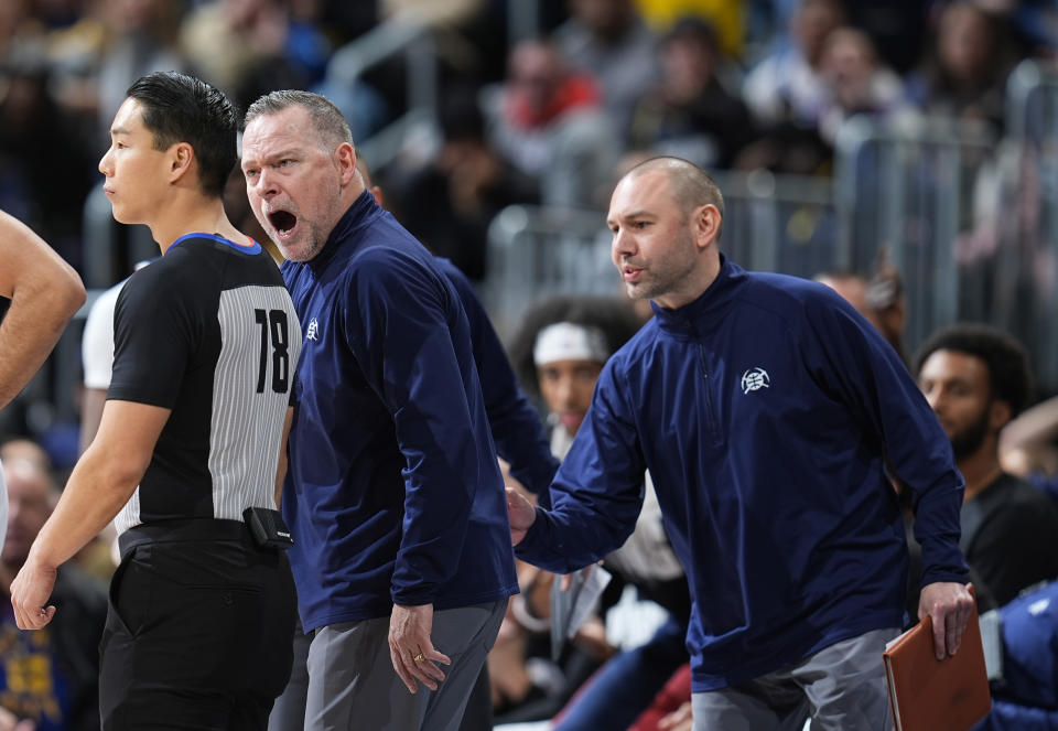 Denver Nuggets assistant coach David Adelman, right, calms head coach Michael Malone, center, left, who yells at referee Evan Scott (78) after a call in the second half of an NBA basketball game against the Indiana Pacers, Sunday, Jan. 14, 2024, in Denver. (AP Photo/David Zalubowski)