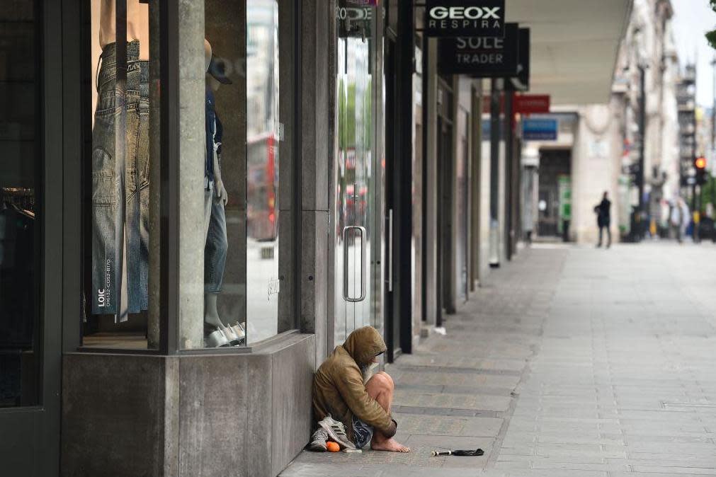 A homeless person is seen on Oxford Street in central London: AFP via Getty Images