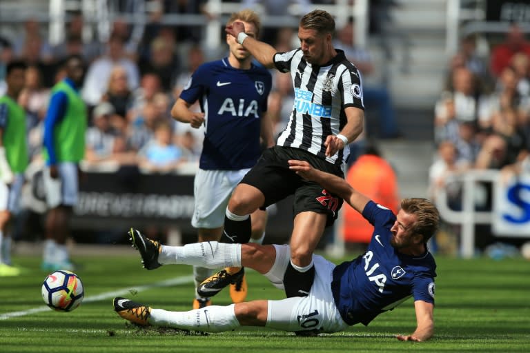 Tottenham Hotspur's striker Harry Kane (R) slides to tackle Newcastle United's midfiielder Florian Lejeune during the English Premier League football match August 13, 2017